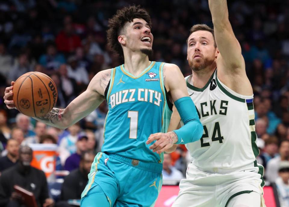 Charlotte Hornets guard LaMelo Ball, left, drives down the baseline as Milwaukee Bucks guard Pat Connaughton, right, applies defensive pressure during second half action on Friday, November 17, 2023 at Spectrum Center in Charlotte, NC. The Bucks defeated the Hornets 130-99.