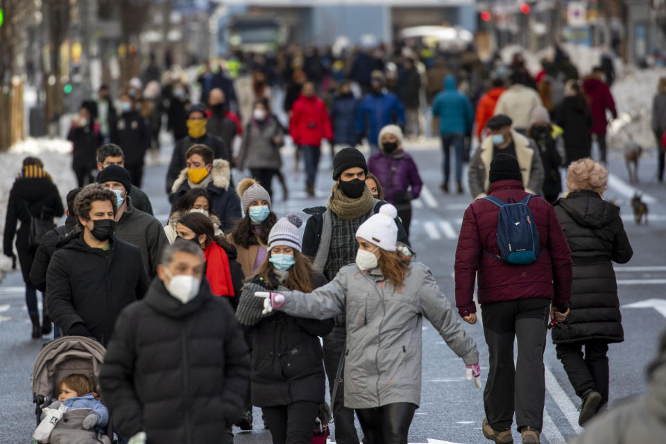 FILE - In this Jan. 10, 2021, file photo, people walk through Gran Via avenue in downtown Madrid, Spain. A large part of central Spain including the capital of Madrid are slowly clearing snow after the country's worst snowstorm in recent memory. While most of Europe kicked off 2021 with earlier curfews or stay-at-home orders, authorities in Spain insist the new coronavirus variant causing havoc elsewhere is not to blame for a sharp resurgence of cases and that the country can avoid a full lockdown even as its hospitals fill up. (AP Photo/Manu Fernandez, File)