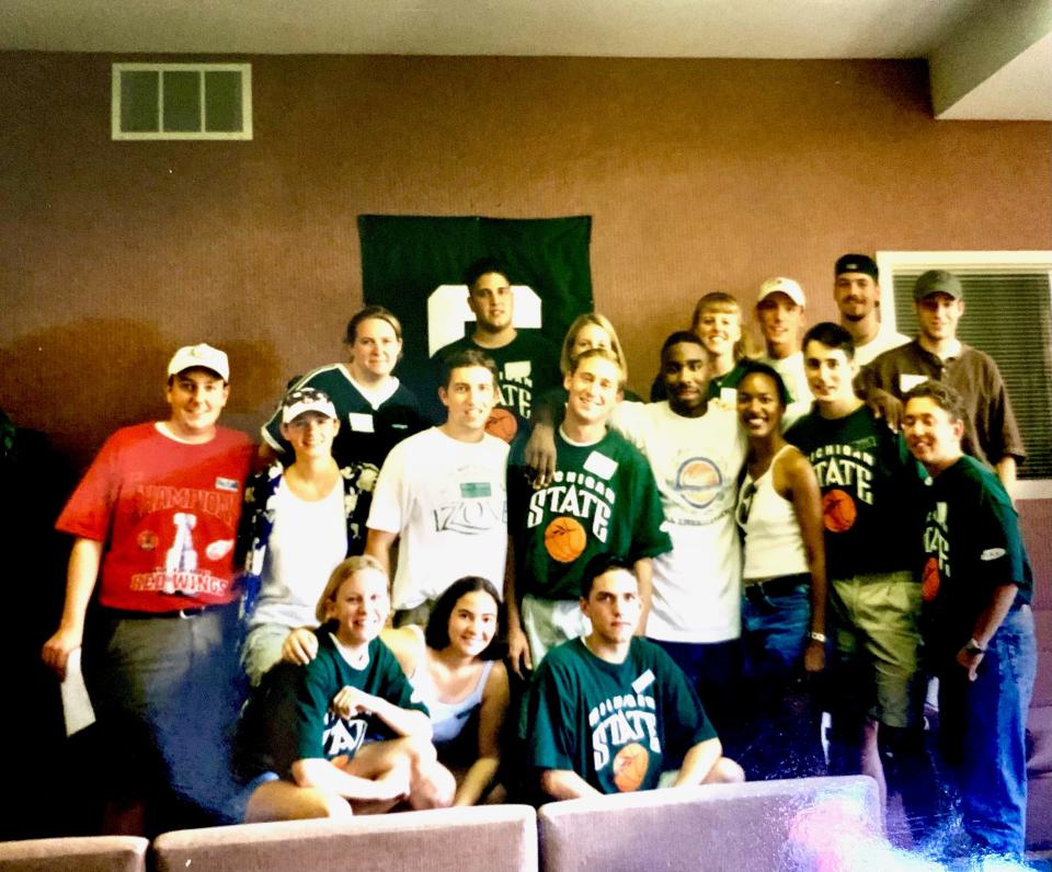 Members of the Izzone pose with former MSU basketball player Mateen Cleaves while selling game tickets to students on campus in the mid-1990s.