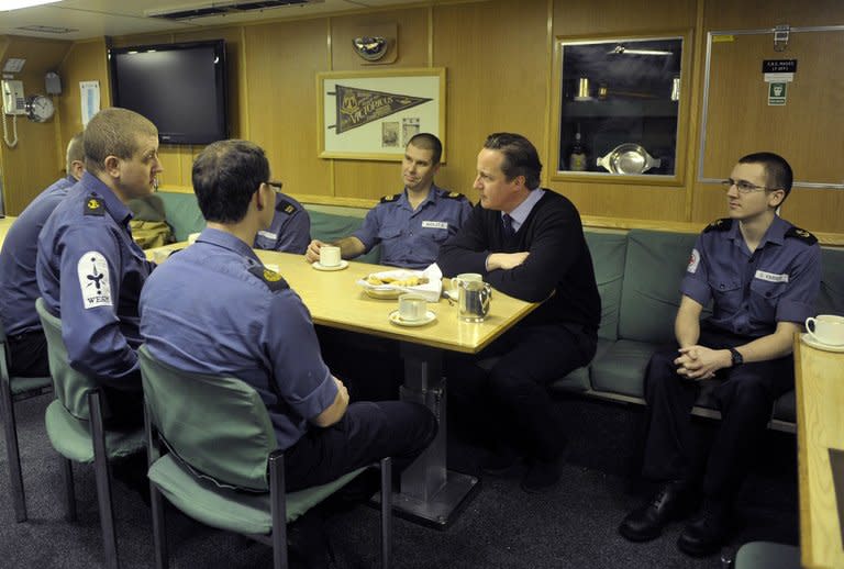 Prime Minister David Cameron speaks with Navy personnel during a visit to the Trident Nuclear Submarine, HMS Victorious, on April 4, 2013. Britain holds a long-standing belief in continuous at-sea deterrence, which requires the running of at least one Vanguard submarine armed with 16 Trident nuclear missiles at any given time