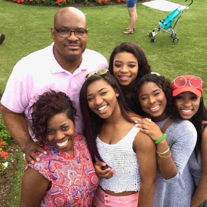 Aaron Owens, who coached football and boys track and field at West High School, died Friday at 56. He is pictured with his wife, Shalonda (front left), and daughters (left to right) Arin, Courtney, Christian and Khilah.