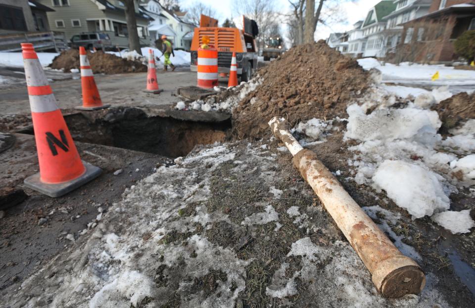 Work crews from the City of Rochester's Department of Environmental Services and the Water Bureau work at replacing lead pipes along the 200 block of Congress Avenue in Rochester Wednesday, March 2, 2022.  At right is an old section of pipe that was replaced. 