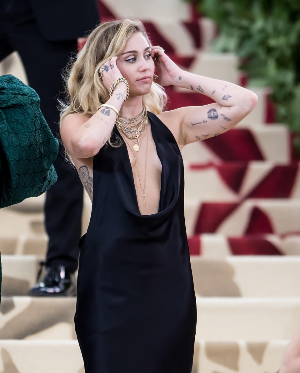 <p>Miley Cyrus has a vast tattoo collection from portraits of her pets to an avocado on her left arm. <em>[Photo: Getty]</em> </p>