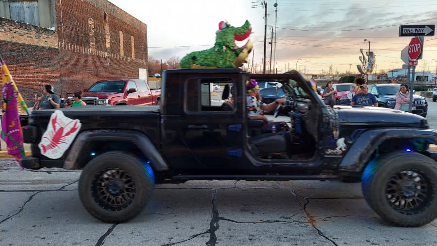 A Jeep decorated for Mardi Gras with an Alligator.