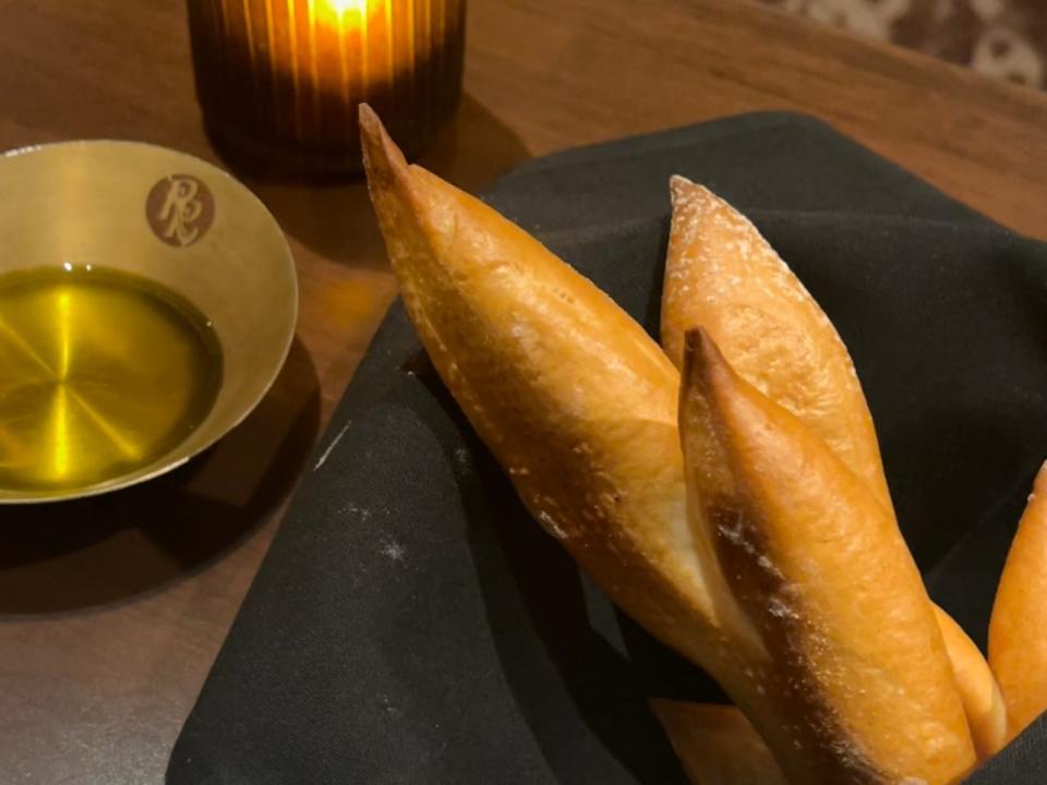 Bread basket with olive oil on table