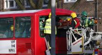 Members of the emergency services attend to a bus which crashed into a tree in Kennington, south London, December 20, 2013. 23 people were injured, two seriously, in the crash according to the Metropolitan Police. REUTERS/Suzanne Plunkett (BRITAIN - Tags: DISASTER TRANSPORT)