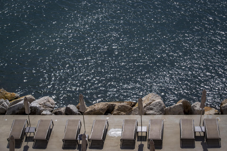 Beach loungers are set for tourists in Opatija, Croatia, Saturday, May 15, 2021. Croatia has opened its stunning Adriatic coastline for foreign tourists after a year of depressing coronavirus lockdowns and restrictions. (AP Photo/Darko Bandic)