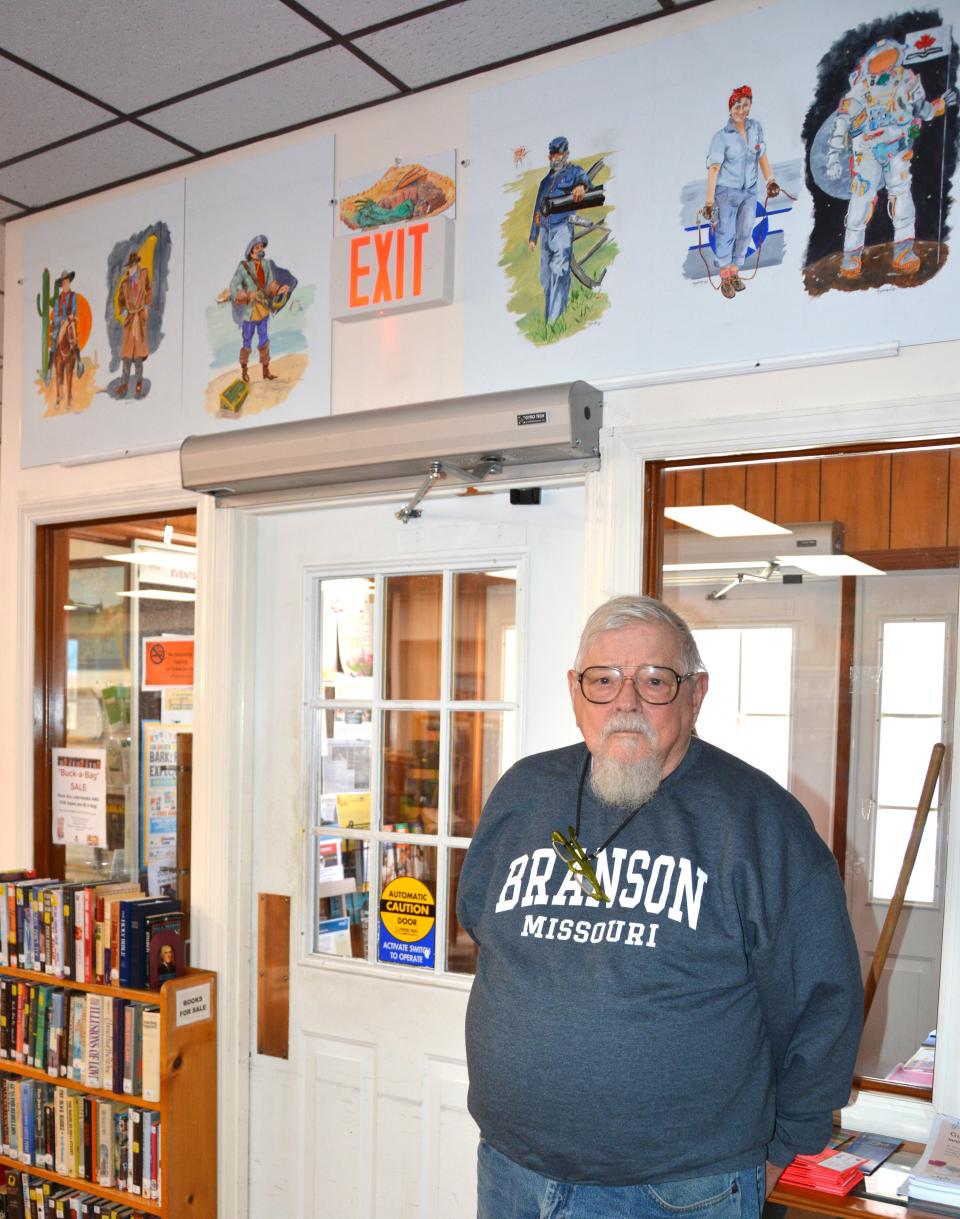 George Menser shows the latest mural project he's done for the Meyersdale Public Library.