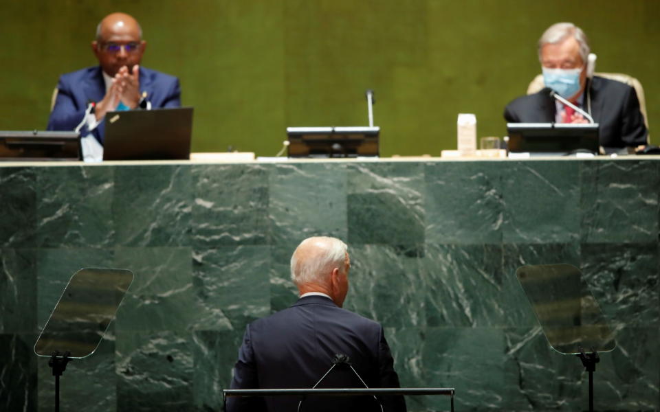 President Biden is applauded Tuesday by the president of the U.N. General Assembly, Abdulla Shahid of the Maldives, as U.N. Secretary-General Antonio Guterres looks on.