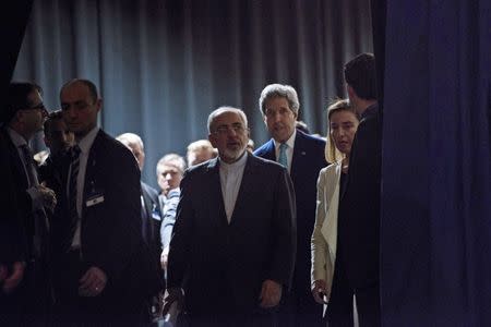 Iranian Foreign Minister Javad Zarif (centre L), U.S. Secretary of State John Kerry (centre R) and European Union High Representative Federica Mogherini (2nd R) arrive to deliver statements after nuclear talks at the Swiss Federal Institute of Technology in Lausanne (Ecole Polytechnique Federale De Lausanne) April 2, 2015. REUTERS/Brendan Smialowski/Pool