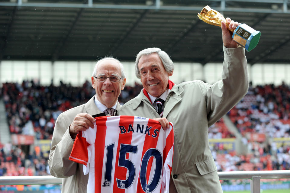 <p>Former Stoke City goalkeeper Gordon Banks holds the Jules Rimet trophy as he is awarded a a Stoke City shirt before the game. </p>