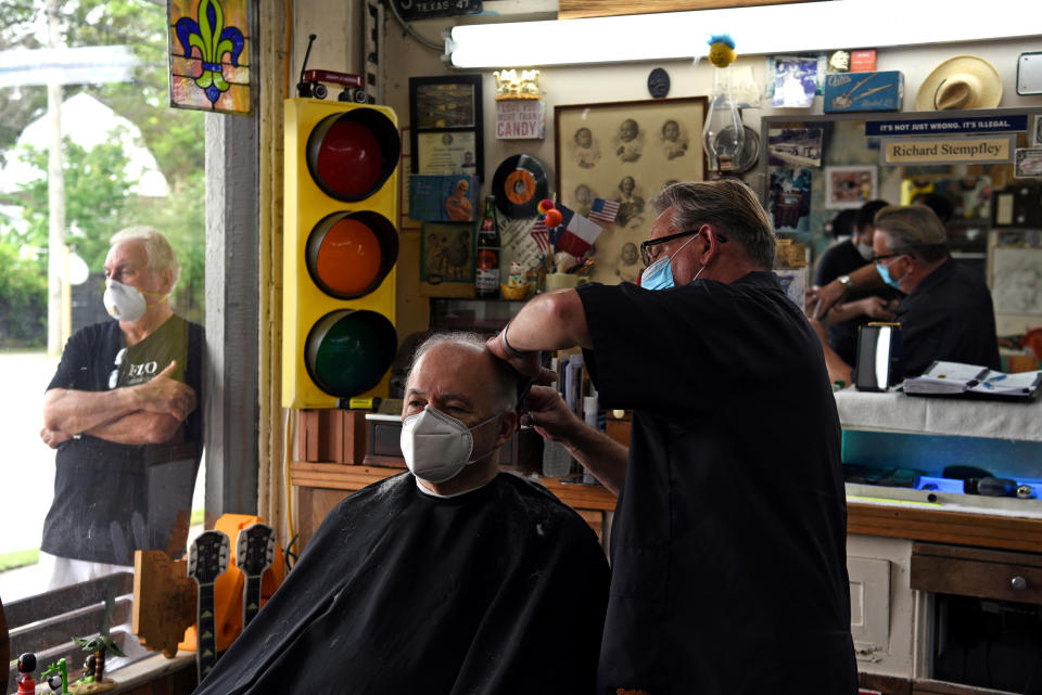 A man receives a haircut as social distancing guidelines to curb the spread of the coronavirus disease (COVID-19) are relaxed, at Dougâs Barber Shop in Houston, Texas, U.S., May 8, 2020. REUTERS/Callaghan O'Hare     TPX IMAGES OF THE DAY