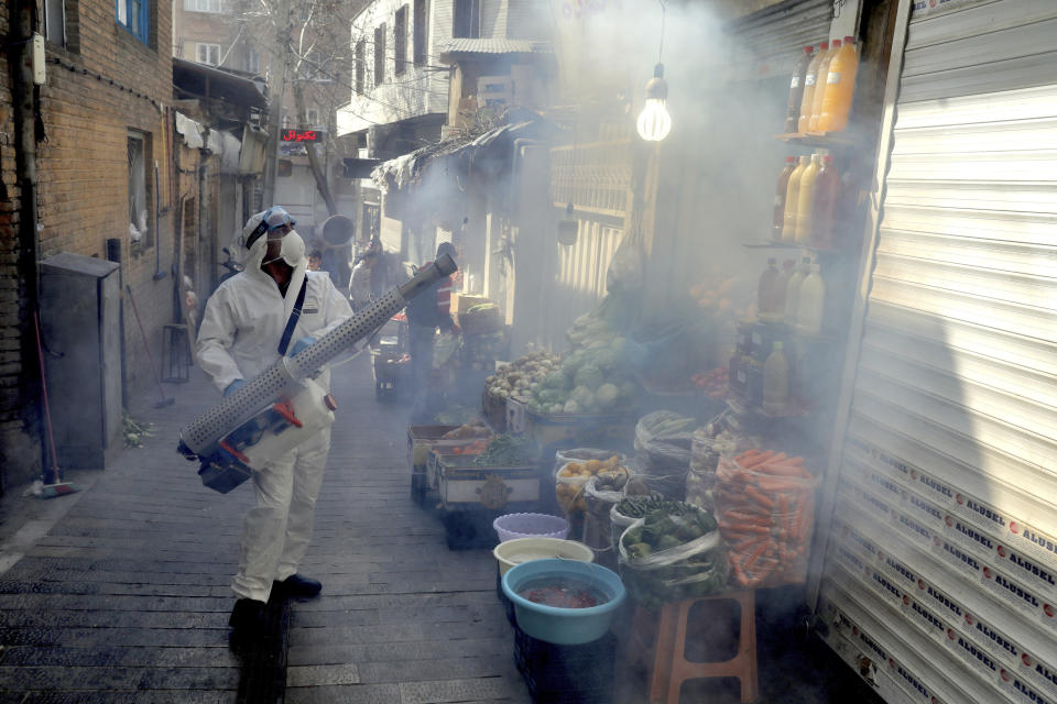 A firefighter disinfects a traditional shopping center to help prevent the spread of the new coronavirus in northern Tehran, Iran, Friday, March, 6, 2020. A Health Ministry spokesman warned authorities could use unspecified “force” to halt travel between major cities. (AP Photo/Ebrahim Noroozi)