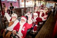 <p>Actors dressed as Santa Claus take a ride on a rollercoaster at the Bakken amusement park in Klampenborg north of Copenhagen, Denmark, on July 24, 2018, as they take part in the World Santa Congress, an annual two-day event held every summer in Copenhagen. (Photo: Mads Claus Rasmussen/Ritzau Scanpix/AFP/Getty Images) </p>