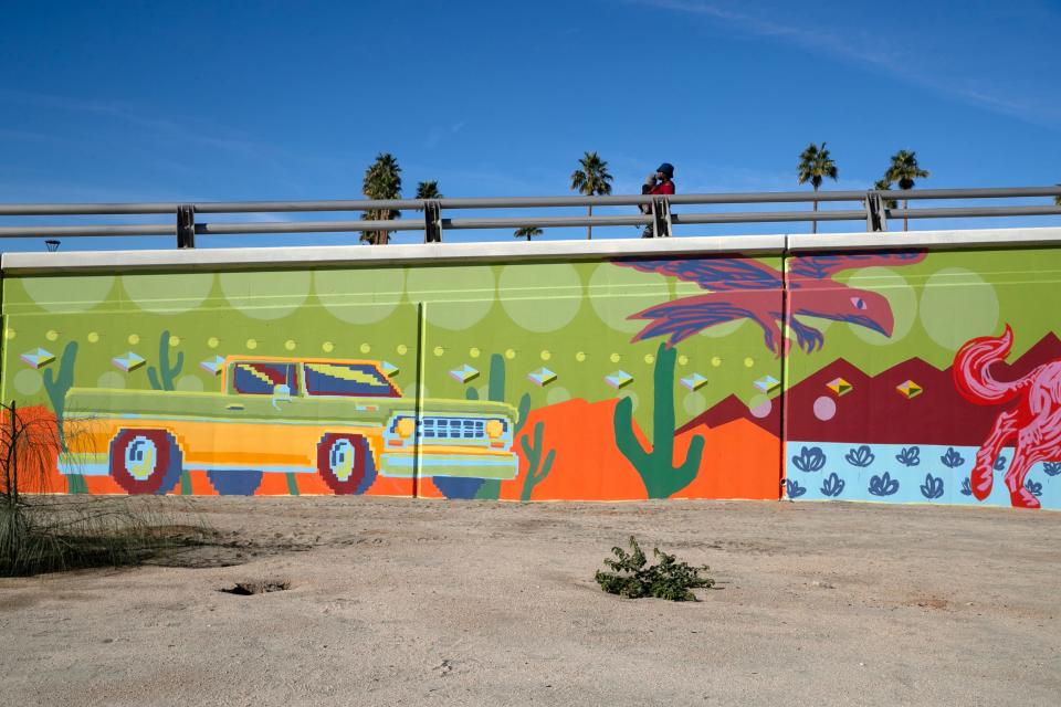 Artists Ivan Montoya and Joey Salamon unveil several murals spanning the length of the Jackson Street Bridge in downtown Indio on Wednesday.