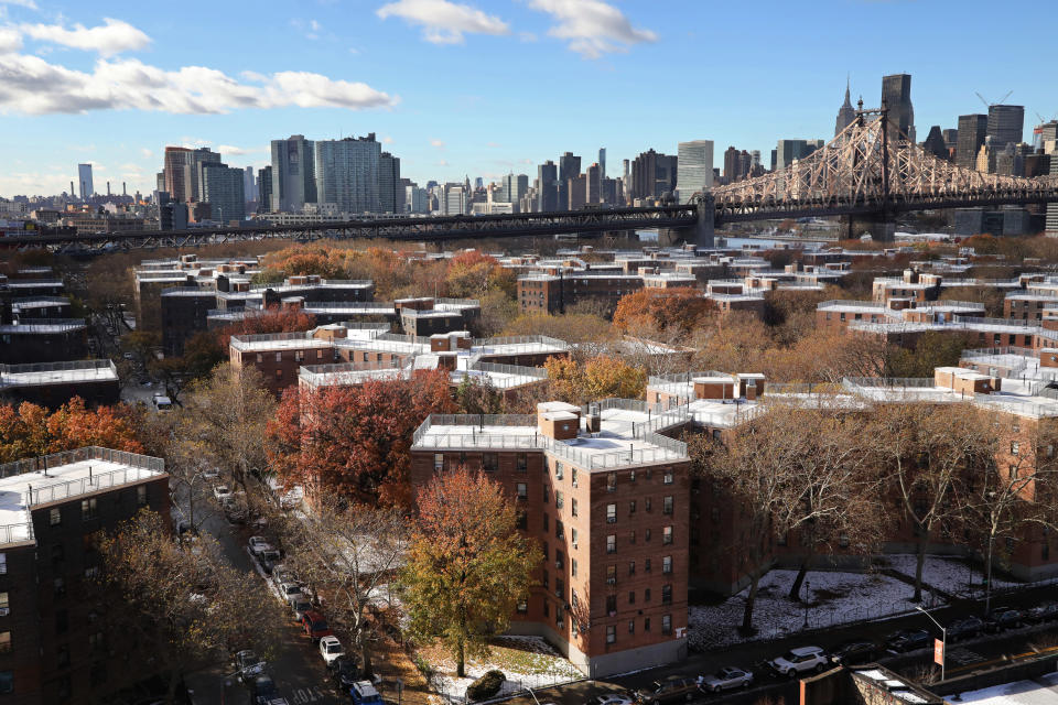 The Queensbridge Houses sit beneath the Ed Koch Queensboro Bridge, upper right, Friday, Nov. 16, 2018, in New York. Like most New York City housing projects, Queensbridge residents complain of poor conditions, lacking heat or hot water, or rats and roaches. The city has come under sharp criticism for the conditions of its public housing. Amazon is proposing to build a new headquarters nearby. (AP Photo/Mark Lennihan)