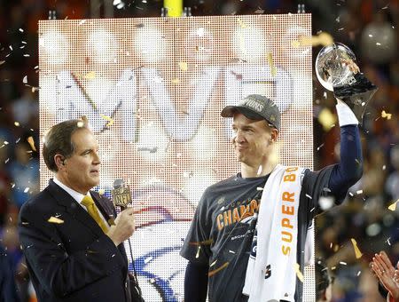 Denver Broncos' quarterback Peyton Manning is interviewed as he holds the Vince Lombardi Trophy after the Broncos defeated the Carolina Panthers in the NFL's Super Bowl 50 football game in Santa Clara, California February 7, 2016. REUTERS/Mike Blake