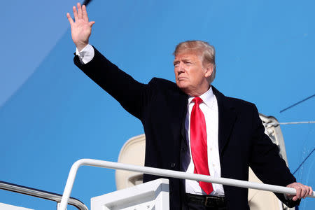 U.S. President Donald Trump waves while boarding Air Force One for travel to Montana from Joint Base Andrews, Maryland, U.S., October 18, 2018. REUTERS/Jonathan Ernst/Files