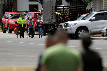 People walk close to the scene where a car bomb exploded, according to authorities, in Bogota, Colombia January 17, 2019. REUTERS/Luisa Gonzalez