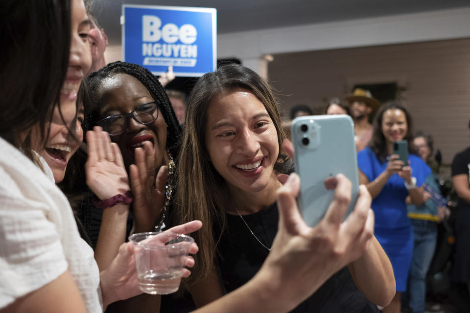 CORRECTS MONTH TO JUNE INSTEAD OF JANUARY - Georgia state Rep. Bee Nguyen FaceTimes with her parents while celebrating Tuesday, June 21, 2022, in Atlanta, after winning a runoff election to be the Democratic candidate for Georgia Secretary of State. (AP Photo/Ben Gray)