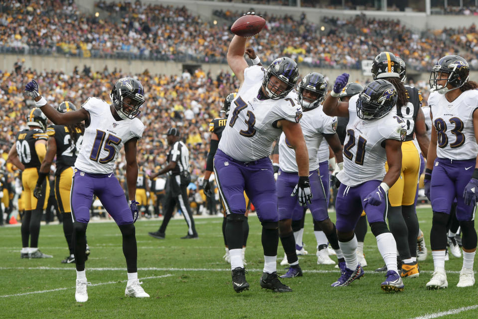 Baltimore Ravens offensive guard Marshal Yanda (73) spikes the football as he celebrates with teammates after running back Mark Ingram (21) scored. (AP Photo/Don Wright)