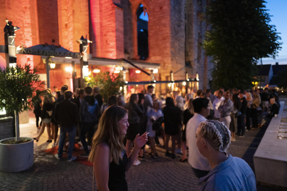 People stand in line without social distancing outside a restaurant in Gotland, Sweden. (Martin von Krogh/Getty Images)