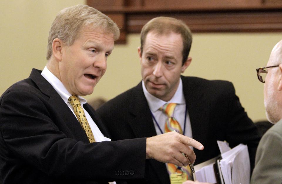 Illinois House Minority Leader Tom Cross, R-Oswego, left, speaks with Jerry Stermer, chief of staff to Illinois Gov. Pat Quinn, right, as a staffer listens in during a House Pension committee hearing at the Illinois State Capitol Thursday, May 31, 2012 in Springfield Ill. (AP Photo/Seth Perlman)