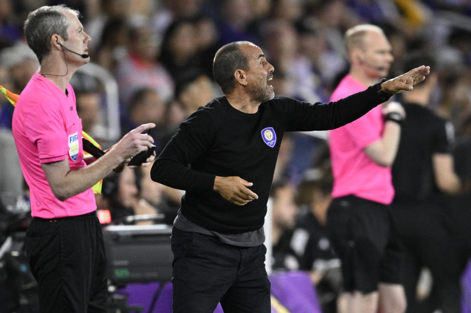 Orlando City head coach Oscar Pareja, center, calls out instructions during the second half of the team's MLS soccer match against Toronto FC, Saturday, April 27, 2024, in Orlando, Fla. (AP Photo/Phelan M. Ebenhack)