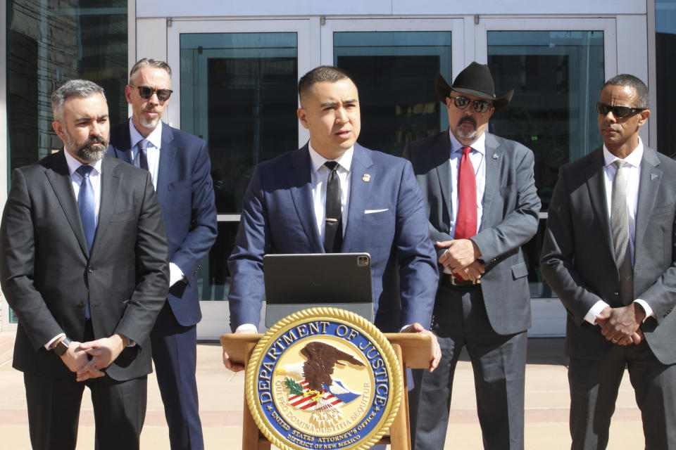 U.S. Attorney for the district of New Mexico Alexander Uballez, center, announces charges against a South Carolina man accused of killing a New Mexico police officer, during a news conference In Albuquerque, N.M., on Friday, March 22, 2024. The defendant, Jeremy Smith, made his initial appearance in court on Friday and was placed in federal custody. (AP Photo/Susan Montoya Bryan)