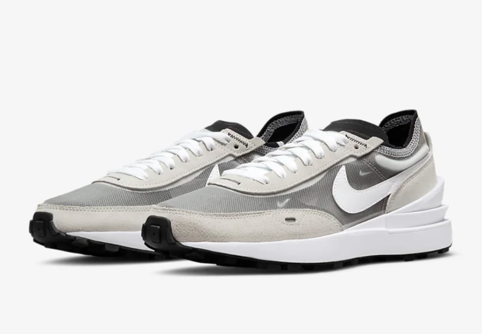 Black and cream shoes with white Swoosh.