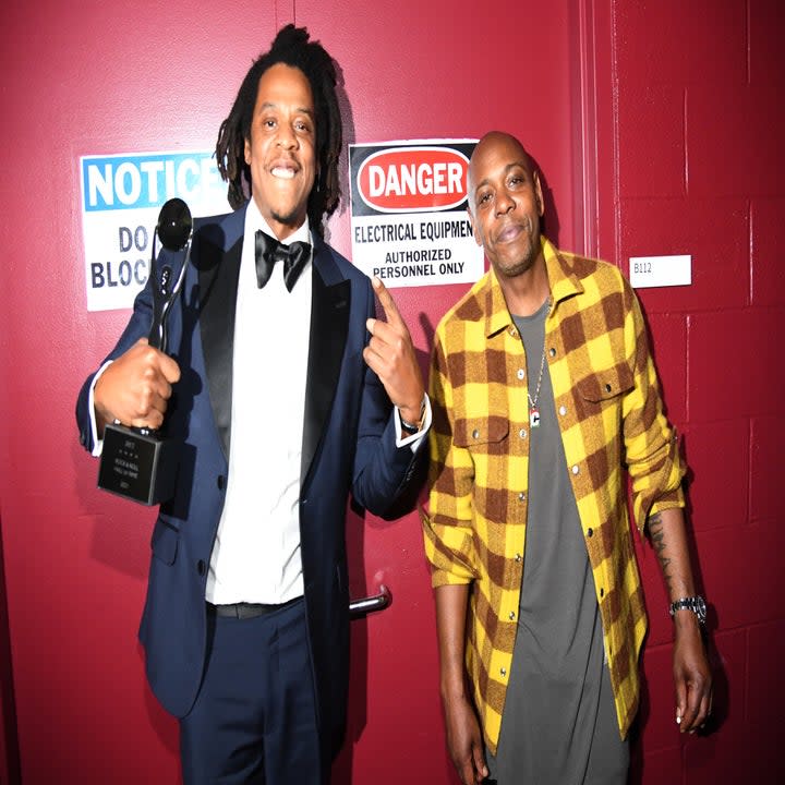 Chappelle and Jay pose backstage while Jay holds an award