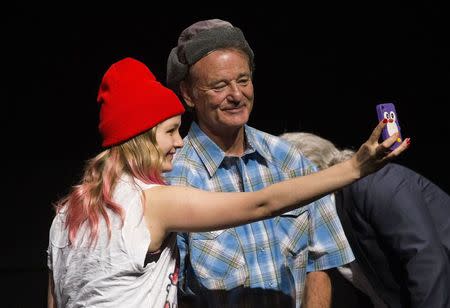 A fan takes a selfie with actor Bill Murray following a screening of "Ghostbusters" at the Toronto International Film Festival (TIFF) in Toronto, September 5, 2014. REUTERS/Mark Blinch
