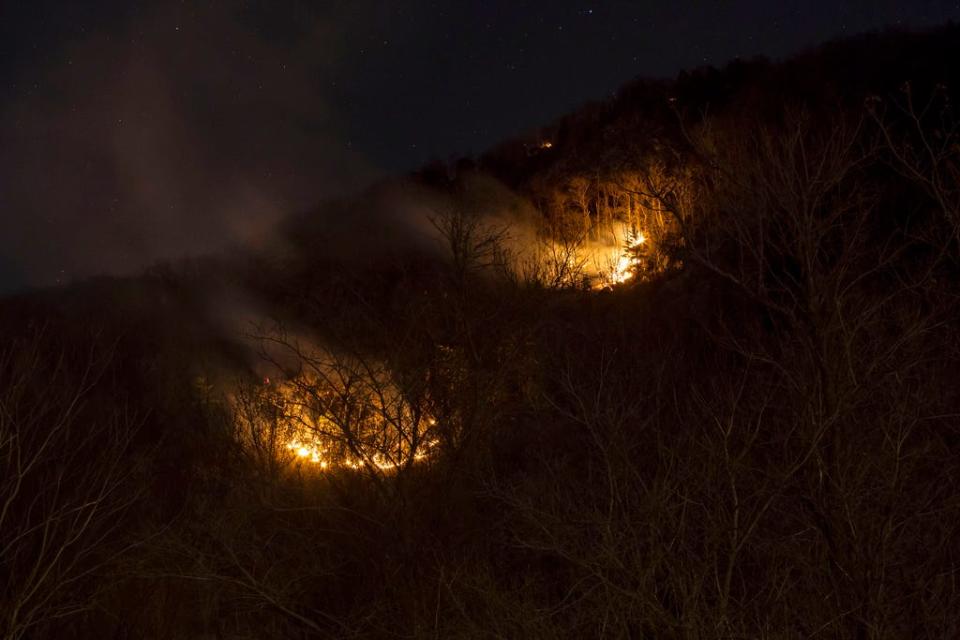 A fire burns on Mount Tammany in the Delaware Water Gap National Recreation Area in Hardwick Township, N.J., on Feb. 23. Firefighters from federal and New Jersey agencies have been battling the forest fire that broke out in a popular hiking area near the Pennsylvania border.