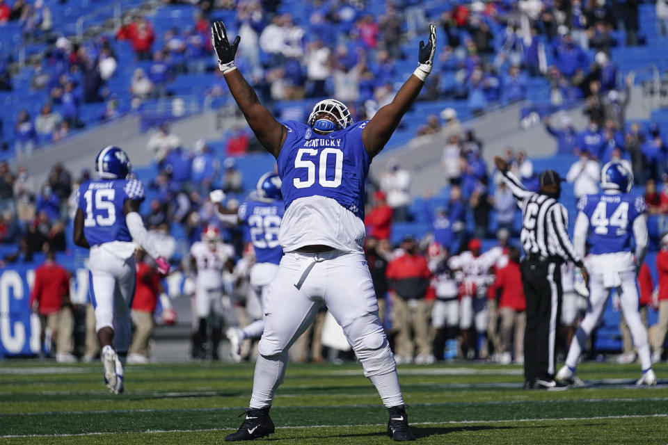 Kentucky defensive tackle Marquan McCall (50) celebrates an interception during the first half of an NCAA college football game against Georgia, Oct. 31, 2020, in Lexington, Ky. (AP Photo/Bryan Woolston)