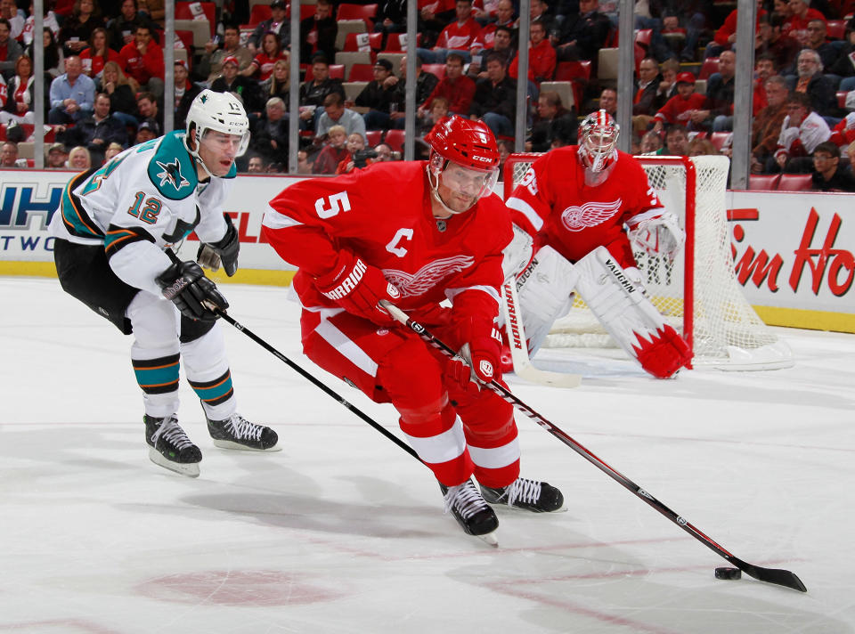 DETROIT, MI - OCTOBER 28: Nicklas Lidstrom #5 of the Detroit Red Wings tries to get around the stick of Patrick Marleau #12 of the San Jose Sharks at Joe Louis Arena on October 28, 2011 in Detroit, Michigan. (Photo by Gregory Shamus/Getty Images)