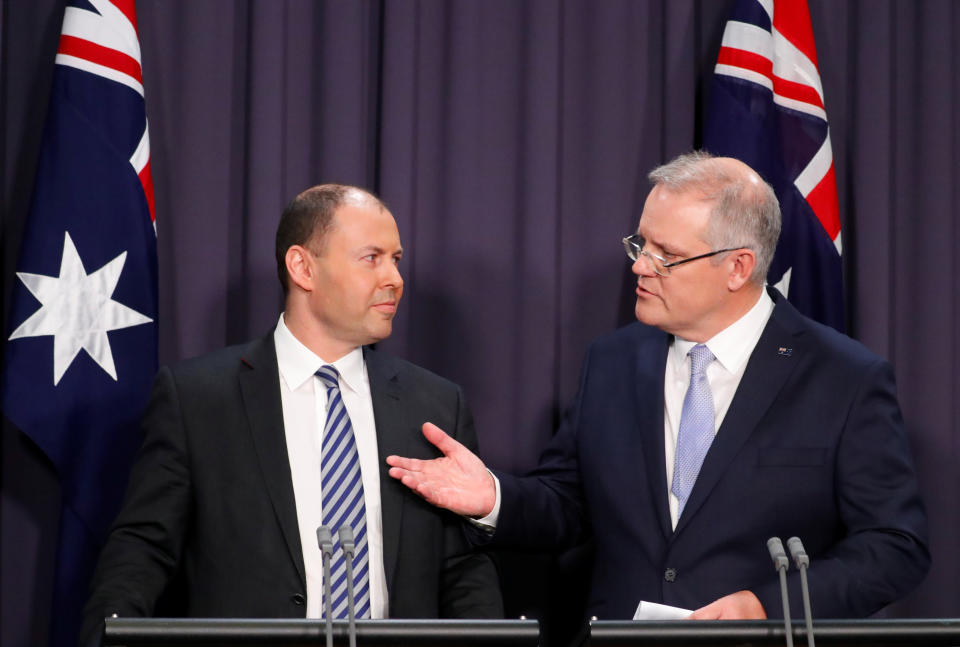 Former Australian prime minister Scott Morrison (r) and former treasurer Josh Frydenberg hold a news conference.