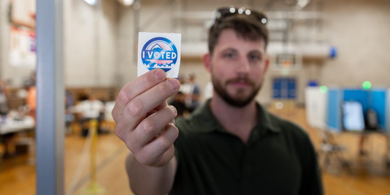 A Nevada voter holds up an "I voted" sticker.