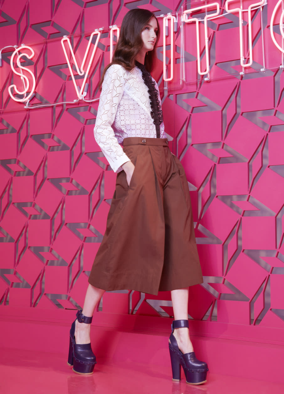 This undated image released by Louis Vuitton shows a model wearing a brown cotton culottes with a tuxedo-style shirt by Louis Vuitton. The Louis Vuitton resort collection harnesses the power of suggestion. There is very little skin shown, yet one just imagines a sultry, confident woman in the layered looks that come with the long silhouette. (AP Photo/Louis Vuitton)