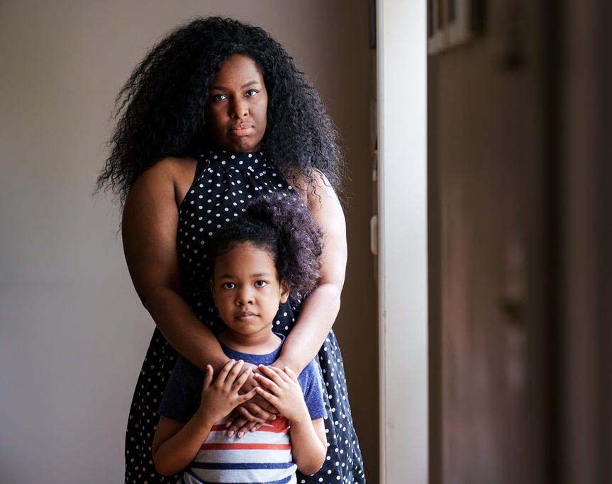 Cynthia Adinig, 37, of Vienna, Virginia, and her son Aiden, 7, at home on Sept. 8. The two have lasting side effects from long COVID, making it difficult to go out because of an increased chance of sudden reactions and flareups.