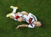 Germany's Bastian Schweinsteiger lies on the pitch in pain after being fouled by Algeria's Rafik Halliche (not pictured) during their 2014 World Cup round of 16 game at the Beira Rio stadium in Porto Alegre June 30, 2014. REUTERS/Fabrizio Bensch