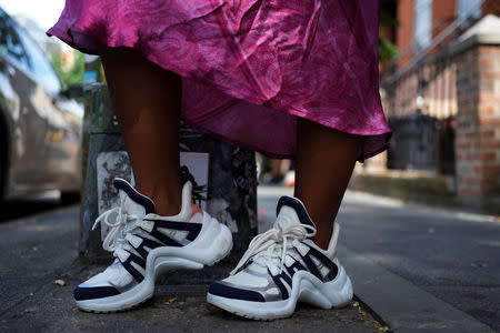 Nia Indigo, 23, a stylist based in New York, poses for a picture wearing a pair of Louis Vuitton Archlight sneakers in the Brooklyn borough of New York, U.S., September 2, 2018. REUTERS/Caitlin Ochs
