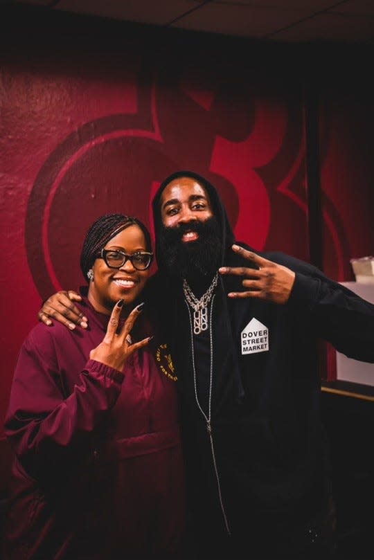 Feb. 16, 2023; James Harden with Arizona State women's basketball head coach Natasha Adair doing the Sun Devil three-finger pitchfork symbol.