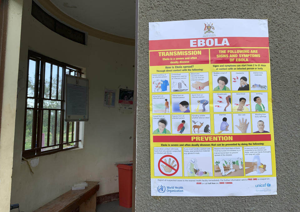 This photo taken Thursday, April 18, 2019 and released by the International Rescue Committee (IRC), shows an Ebola-prevention information sign at the Ndaiga Health Centre II, near the shores of Lake Albert and the border with Congo, in Kagadi district, western Uganda. Uganda's health ministry said late Tuesday, June 11, 2019 that a child in Uganda has tested positive for Ebola in the first cross-border case of the deadly virus since an outbreak started in neighboring Congo last year. (Ben Wise/International Rescue Committee via AP)