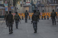 Paramilitary soldiers patrol a deserted street on the first anniversary of India’s decision to revoke the disputed region’s semi-autonomy, in Srinagar, Indian controlled Kashmir, Wednesday, Aug. 5, 2020. Last year on Aug. 5, India’s Hindu-nationalist-led government of Prime Minister Narendra Modi stripped Jammu-Kashmir of its statehood and divided it into two federally governed territories. Late Tuesday, authorities lifted a curfew in Srinagar but said restrictions on public movement, transport and commercial activities would continue because of the coronavirus pandemic. (AP Photo/ Dar Yasin)