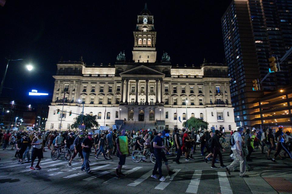 Protesters march past the Wayne County Building on Randolph Road in downtown Detroit, Wednesday, June 3, 2020.