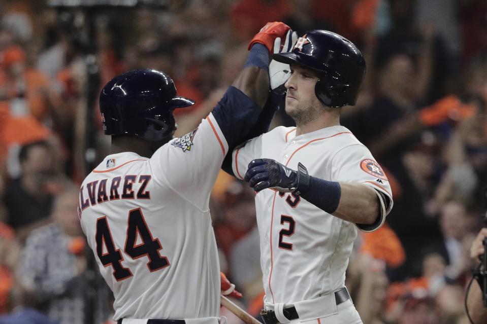 Houston Astros' Alex Bregman is congratulated by Yordan Alvarez after hitting a home run during the first inning of Game 6 of the baseball World Series against the Washington Nationals Tuesday, Oct. 29, 2019, in Houston. (AP Photo/David J. Phillip)