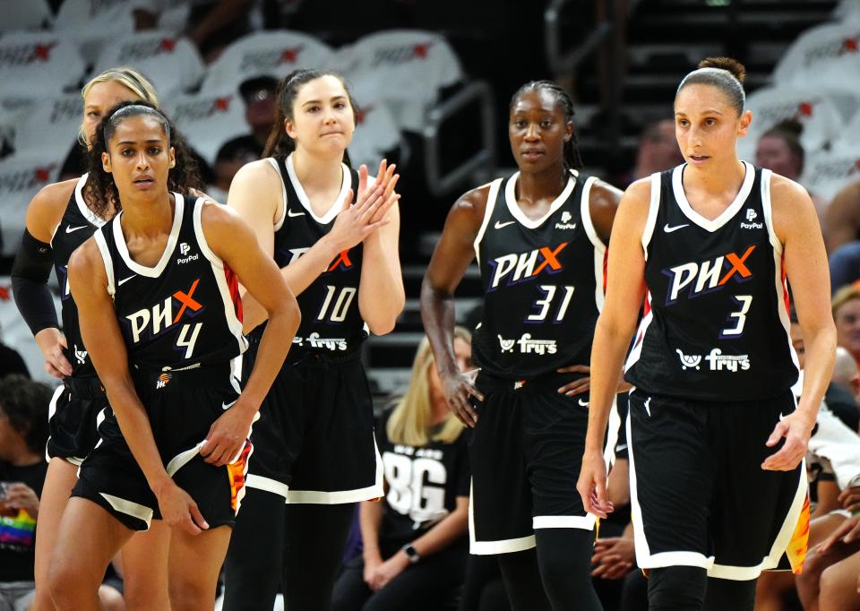 The Mercury huddle together before coming back from a timeout down double digits to the Aces in the first quarter during the home opener.