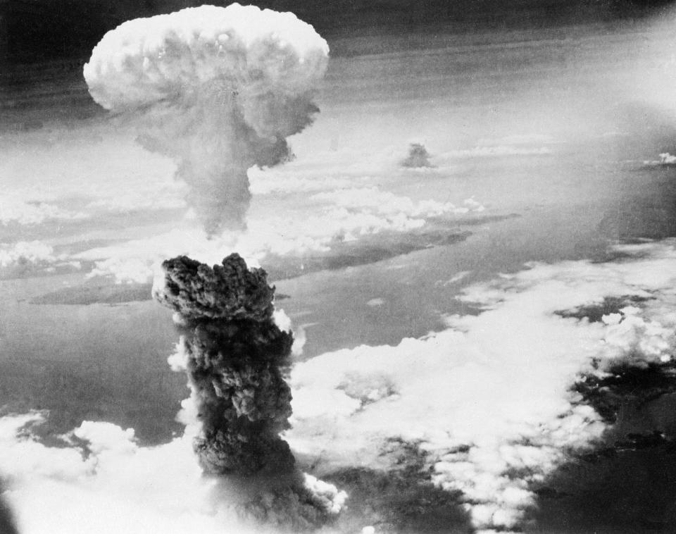 FILE - In this Aug. 9, 1945, file photo, a giant column of smoke rises after the second atomic bomb ever used in warfare explodes over the Japanese port town of Nagasaki. The city of Nagasaki in southern Japan marks the 75th anniversary of the U.S. atomic bombing of Aug. 9, 1945. Japan surrendered on Aug. 15, ending World War II and its nearly a half-century aggression toward Asian neighbors. Dwindling survivors, whose average age exceeds 83, increasingly worry about passing their lessons on to younger generations. (AP Photo, File)