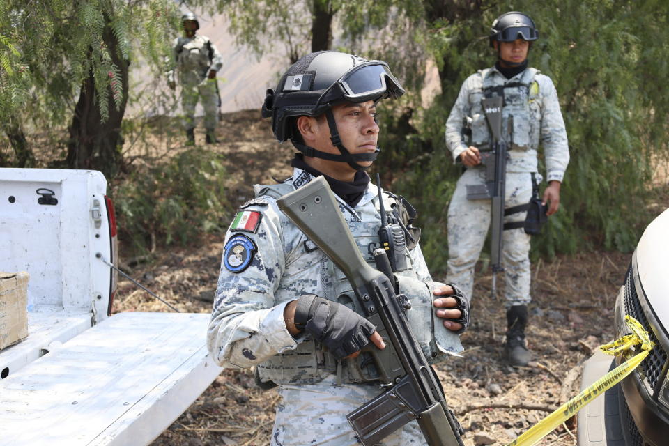 National Guards stand at the site where volunteer searchers said they found a clandestine crematorium in Tlahuac, on the edge of Mexico City, Wednesday, May 1, 2024. Ceci Flores, a leader of one of the groups of so-called "searching mothers" from northern Mexico, announced late Tuesday that her team had found bones around clandestine burial pits and ID cards, and prosecutors said they were investigating to determine the nature of the remains found. (AP Photo/Ginnette Riquelme)