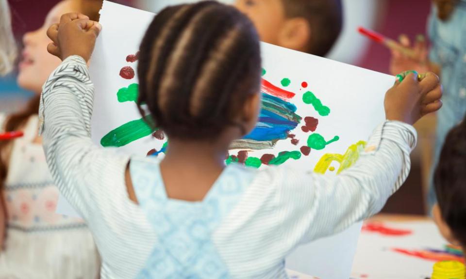 Girl holding painting in class